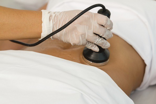 Close up of a woman getting a cavitation treatment
